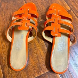Salvatore Ferragamo tangerine, patent leather slide in sandals w/leather sole.